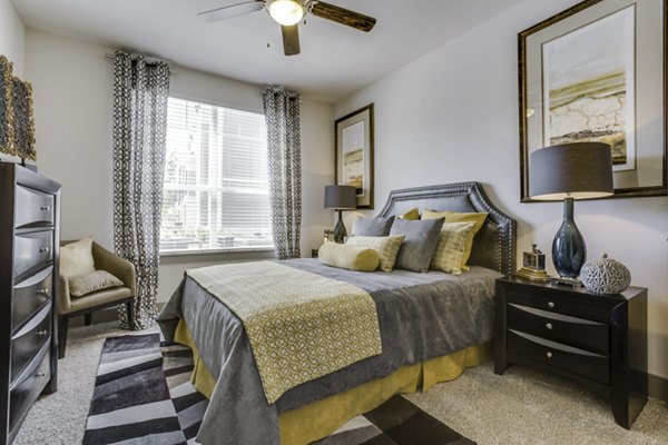 Bedroom with modern decor and ample natural light at The Grayson Apartments Stylish living in Greystar luxury apartments