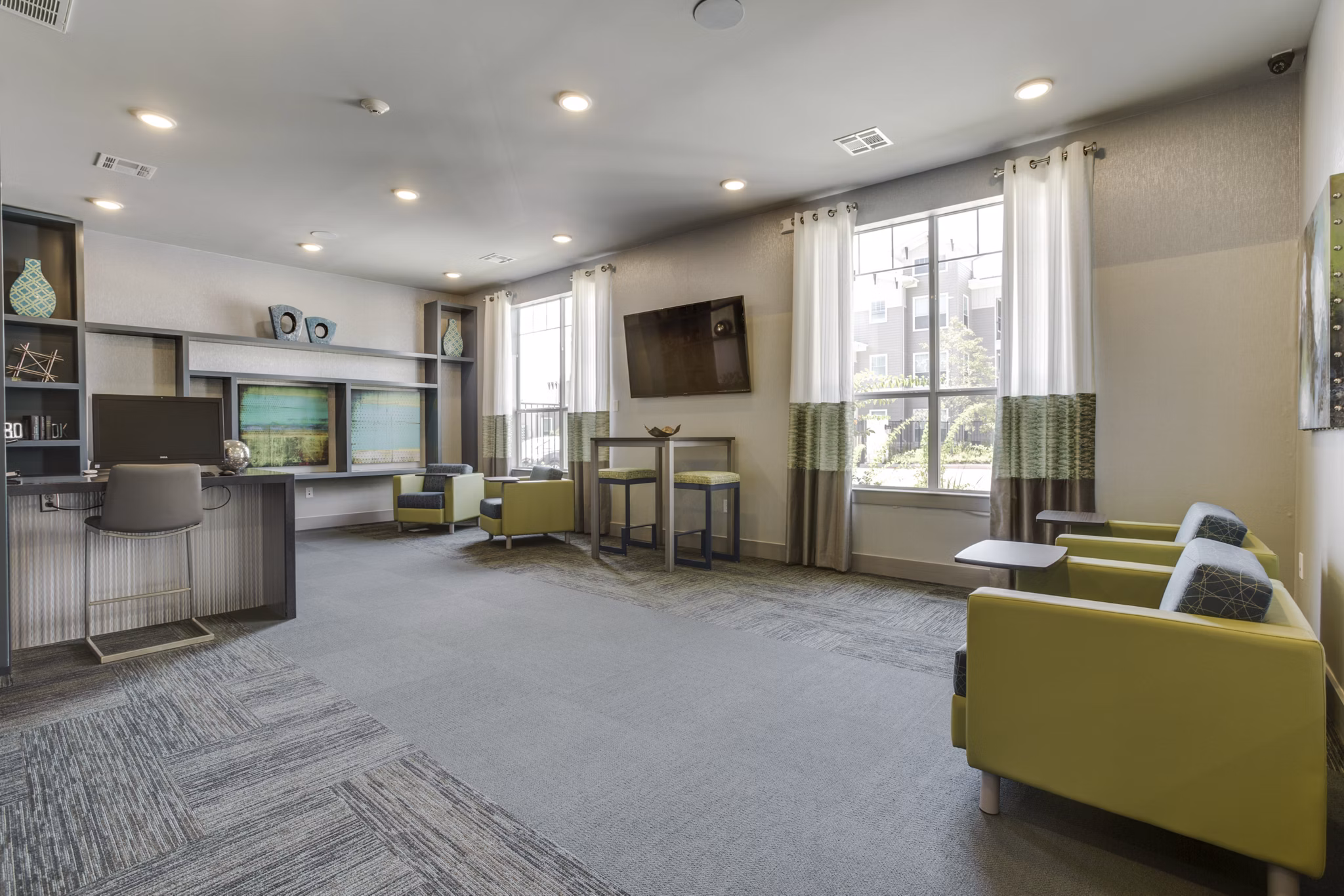 Elegant clubhouse with modern decor at The Grayson Apartments, featuring luxurious seating and community space