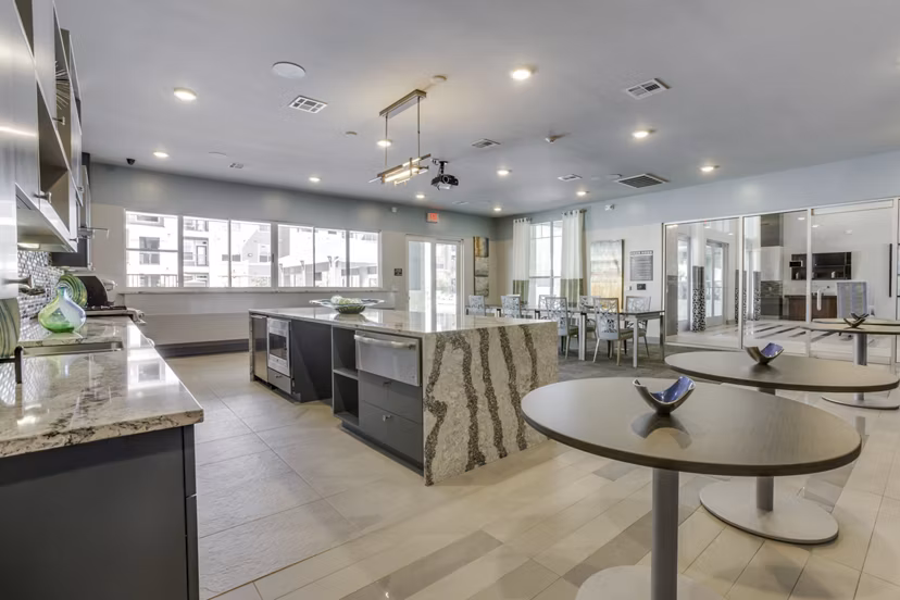 Elegant clubhouse with modern decor at The Grayson Apartments, ideal for social gatherings and luxury living experiences