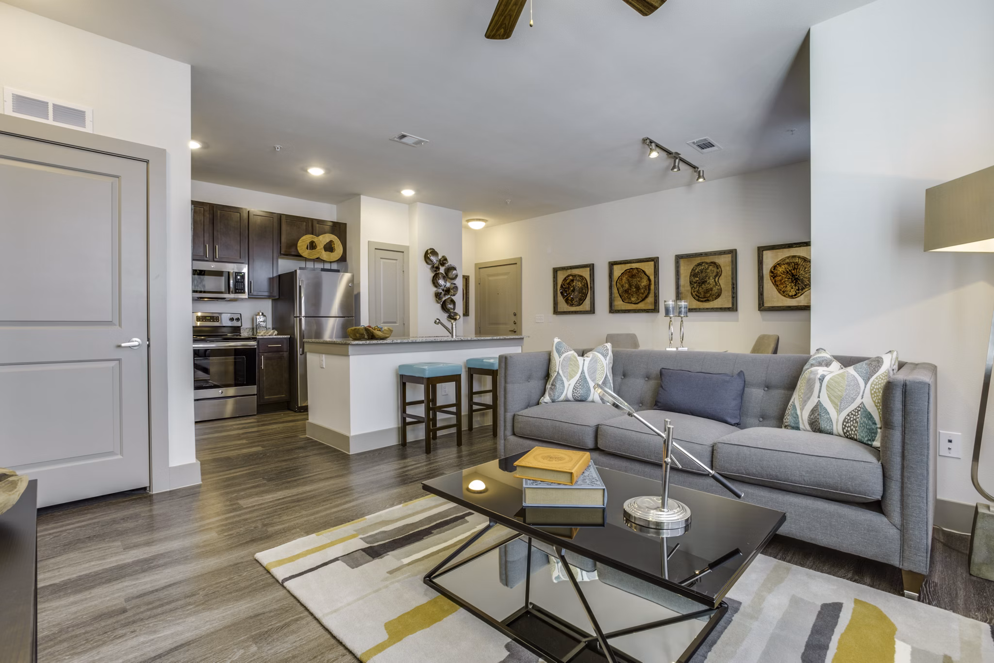 Modern living room with natural lighting and sleek furnishings at The Grayson Apartments in a luxurious Greystar community
