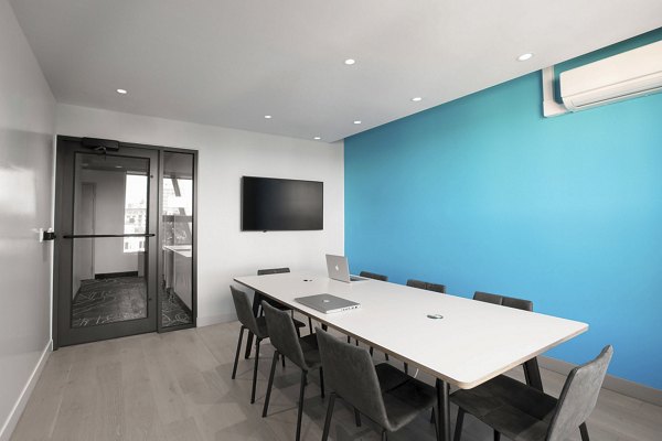 Clubhouse meeting facility with modern seating and large conference table at Watermark Central Apartments