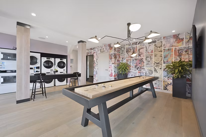 Game room with billiards table and laundry facility clubhouse at Watermark Central Apartments, offering luxury amenities and a vibrant community space