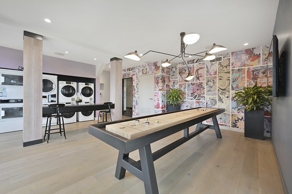 Game room with billiards table and laundry facility clubhouse at Watermark Central Apartments, offering luxury amenities and a vibrant community space
