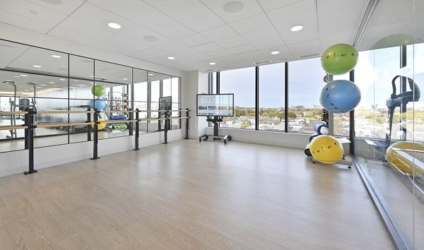 Yoga studio with natural light and bamboo flooring at Watermark Central Apartments luxury space, perfect for fitness and relaxation