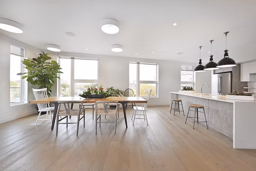 Dining room and kitchen featuring modern appliances and chic dÃ©cor at Watermark Central Apartments