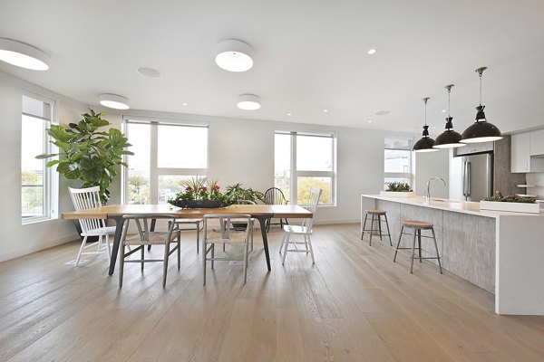 Dining room and kitchen featuring modern appliances and chic dÃ©cor at Watermark Central Apartments