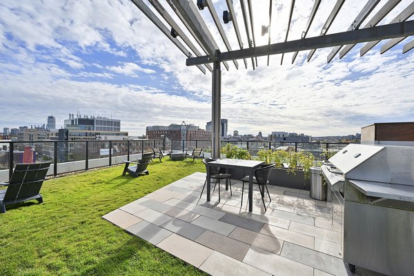 Outdoor grill area and patio at Watermark Central Apartments with cozy seating and modern design for luxury living