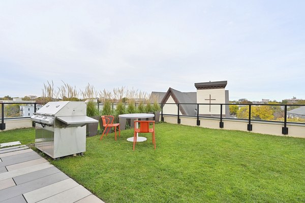 Outdoor grill area with modern patio at Watermark Central Apartments, perfect for entertaining and relaxation