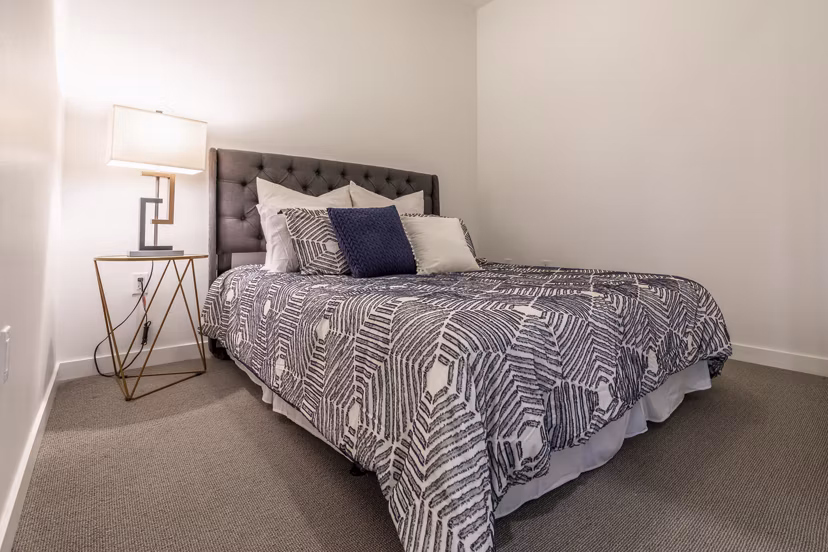 Cozy bedroom with modern decor at Pike Motorworks Apartments in luxury Seattle neighborhood
