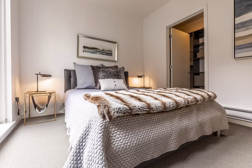 Spacious bedroom with large windows at Pike Motorworks Apartments, offering modern luxury living in Seattle's vibrant Capitol Hill neighborhood