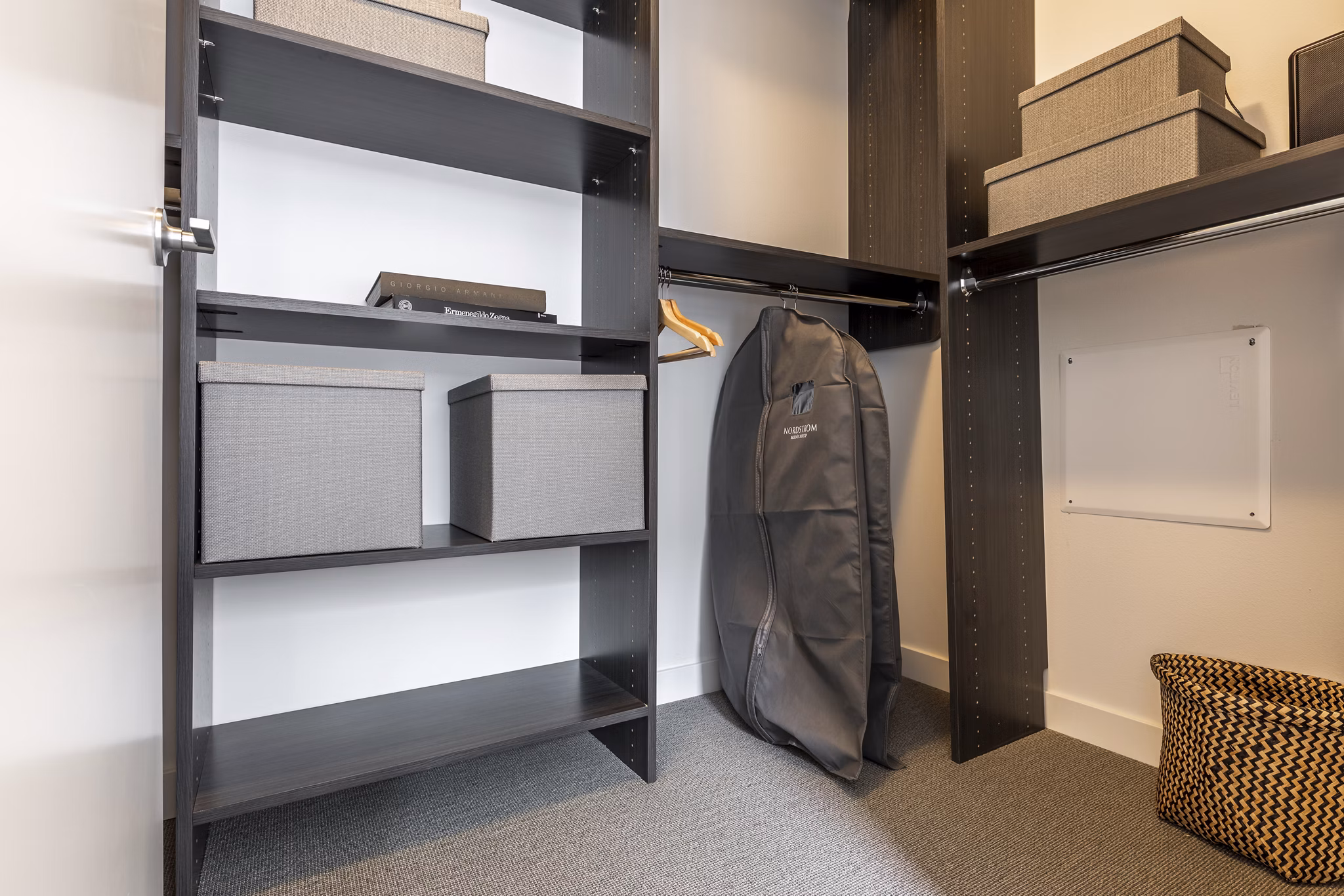 Walk-in closet with organized shelving at Pike Motorworks Apartments