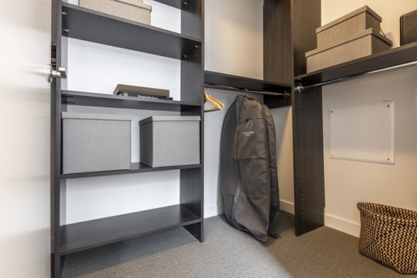 Walk-in closet with organized shelving at Pike Motorworks Apartments