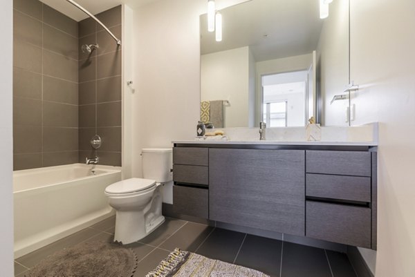 Luxurious bathroom featuring modern fixtures and elegant design at Pike Motorworks Apartments