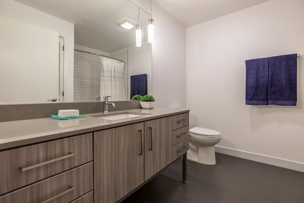 Bathroom with sleek vanity and modern fixtures at Pike Motorworks Apartments in Seattle