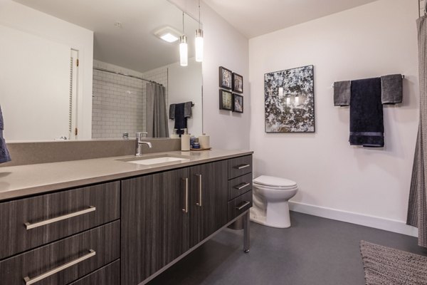 Modern bathroom with sleek fixtures at Pike Motorworks Apartments