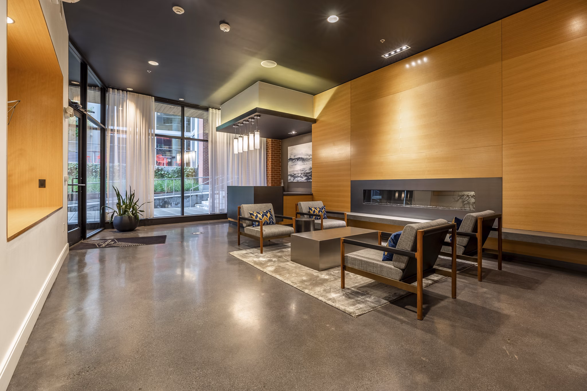 Clubhouse with modern decor and seating at Pike Motorworks Apartments, perfect for social events and gatherings