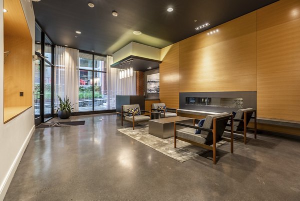 Clubhouse with modern decor and seating at Pike Motorworks Apartments, perfect for social events and gatherings