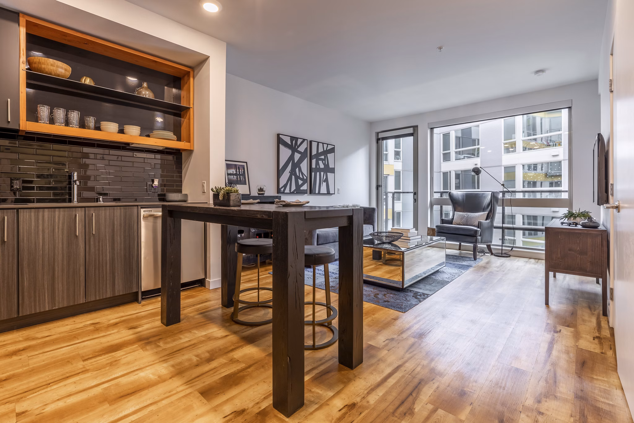 Modern kitchen with stainless steel appliances at Pike Motorworks Apartments