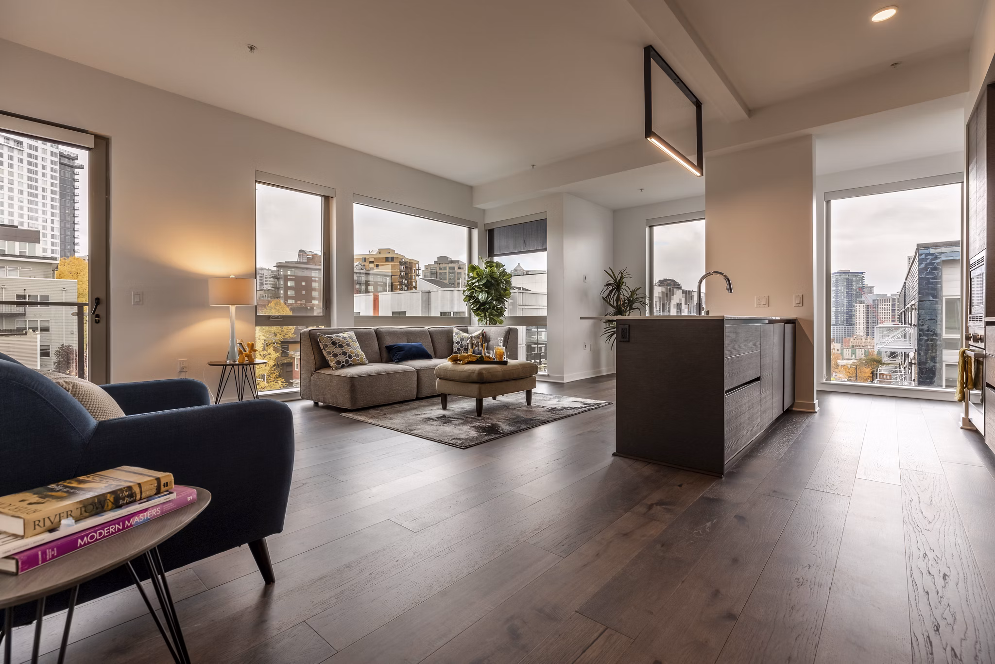 Spacious living room with modern furnishings at Pike Motorworks Apartments