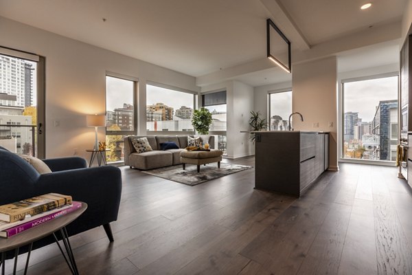 Spacious living room with modern furnishings at Pike Motorworks Apartments