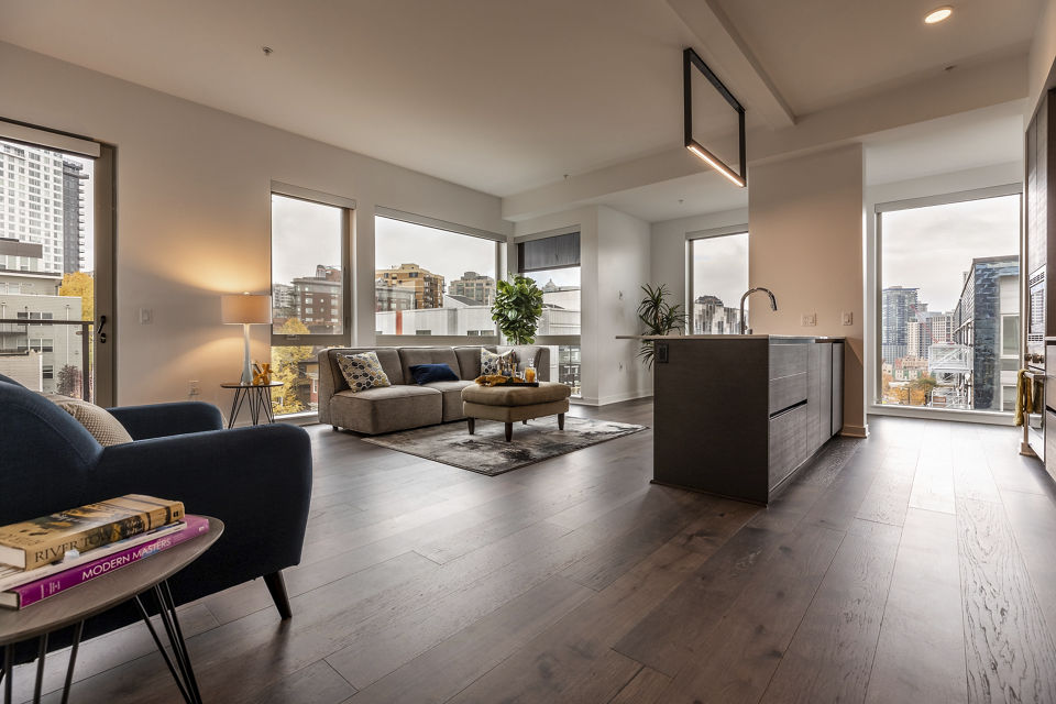Spacious living room with modern furnishings at Pike Motorworks Apartments