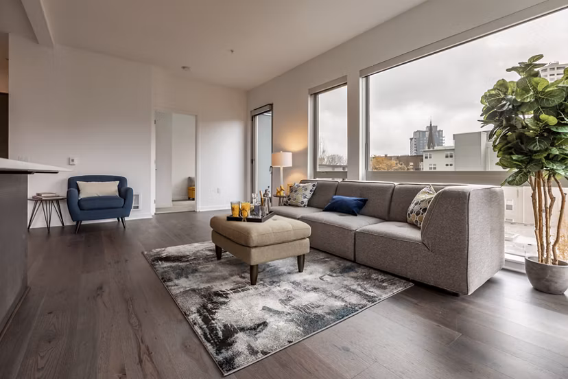 Living room featuring sleek furnishings and urban design at Pike Motorworks Apartments