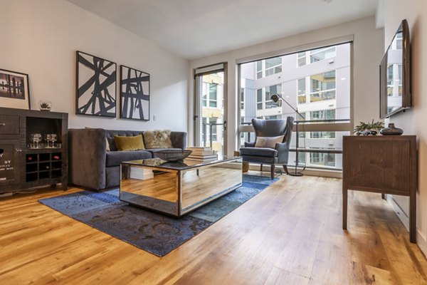 Spacious living room with sleek furnishings at Pike Motorworks Apartments