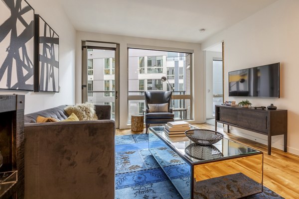 Spacious living room with stylish furnishings at Pike Motorworks Apartments, showcasing luxury apartment living in a vibrant Seattle community