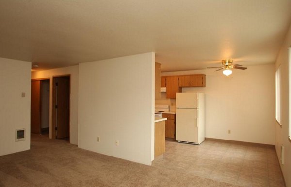 Spacious living room with modern furniture at Village East Apartments, showcasing luxury style and comfort
