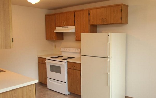 Modern kitchen featuring stainless steel appliances at Village East Apartments