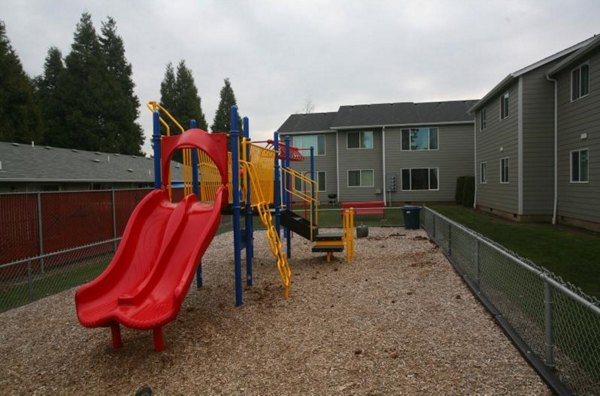 Playground with modern equipment at Village East Apartments, offering family-friendly amenities for residents