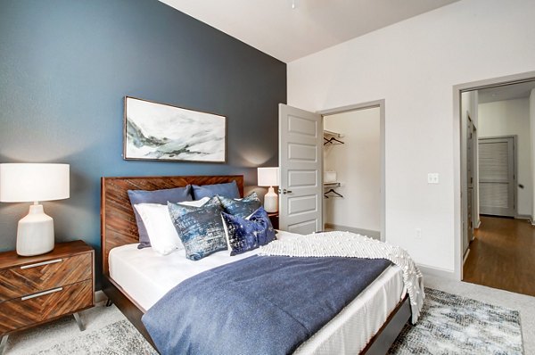 Cozy bedroom with modern furnishings at Mason at Alameda Station Apartments, offering luxury living in a prime urban location