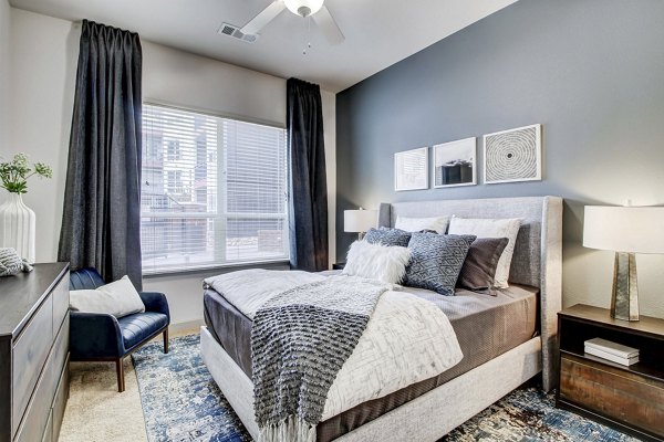 Bedroom featuring modern decor and large windows in Mason at Alameda Station Apartments