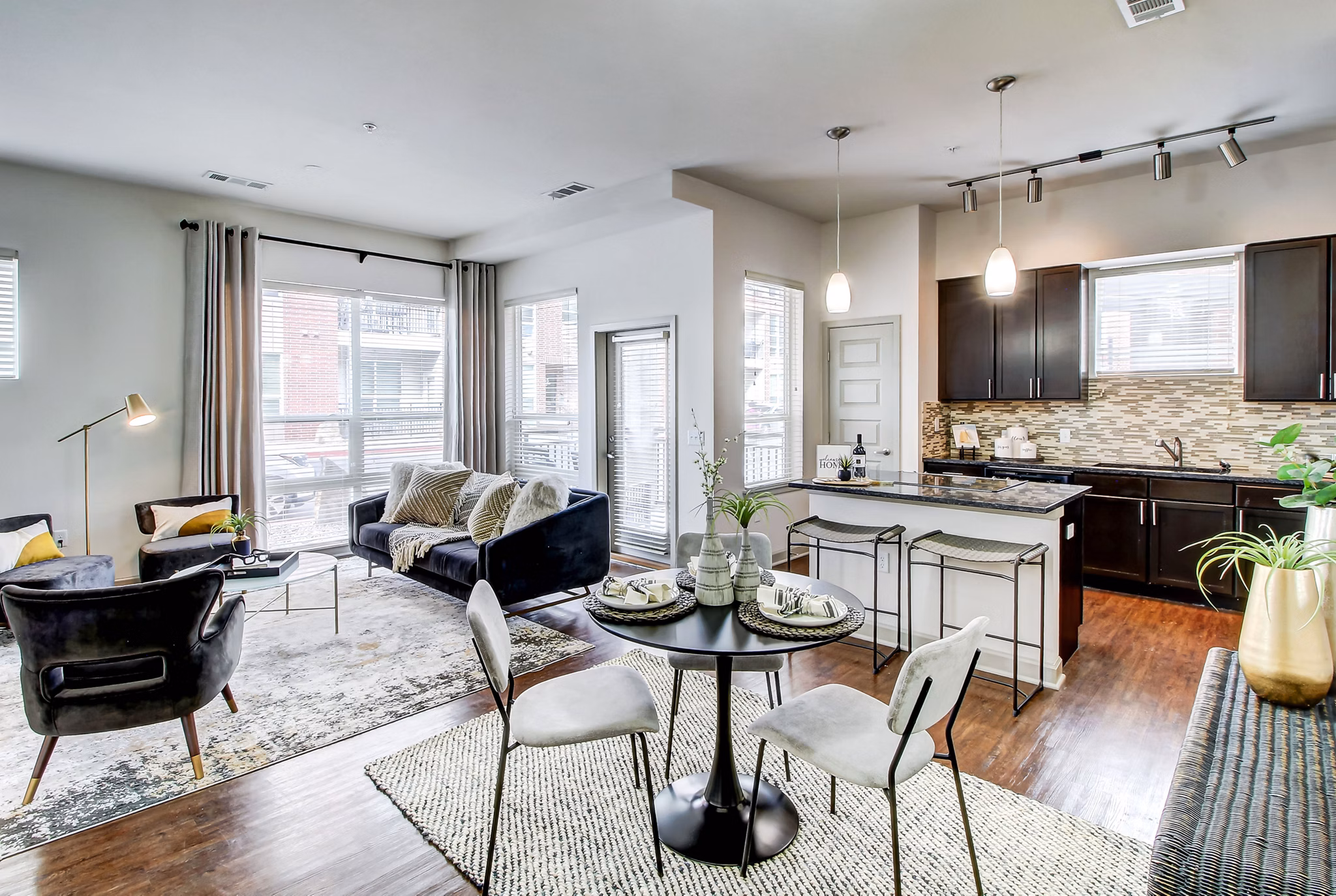 Dining area with modern seating and pendant lighting at Mason at Alameda Station Apartments