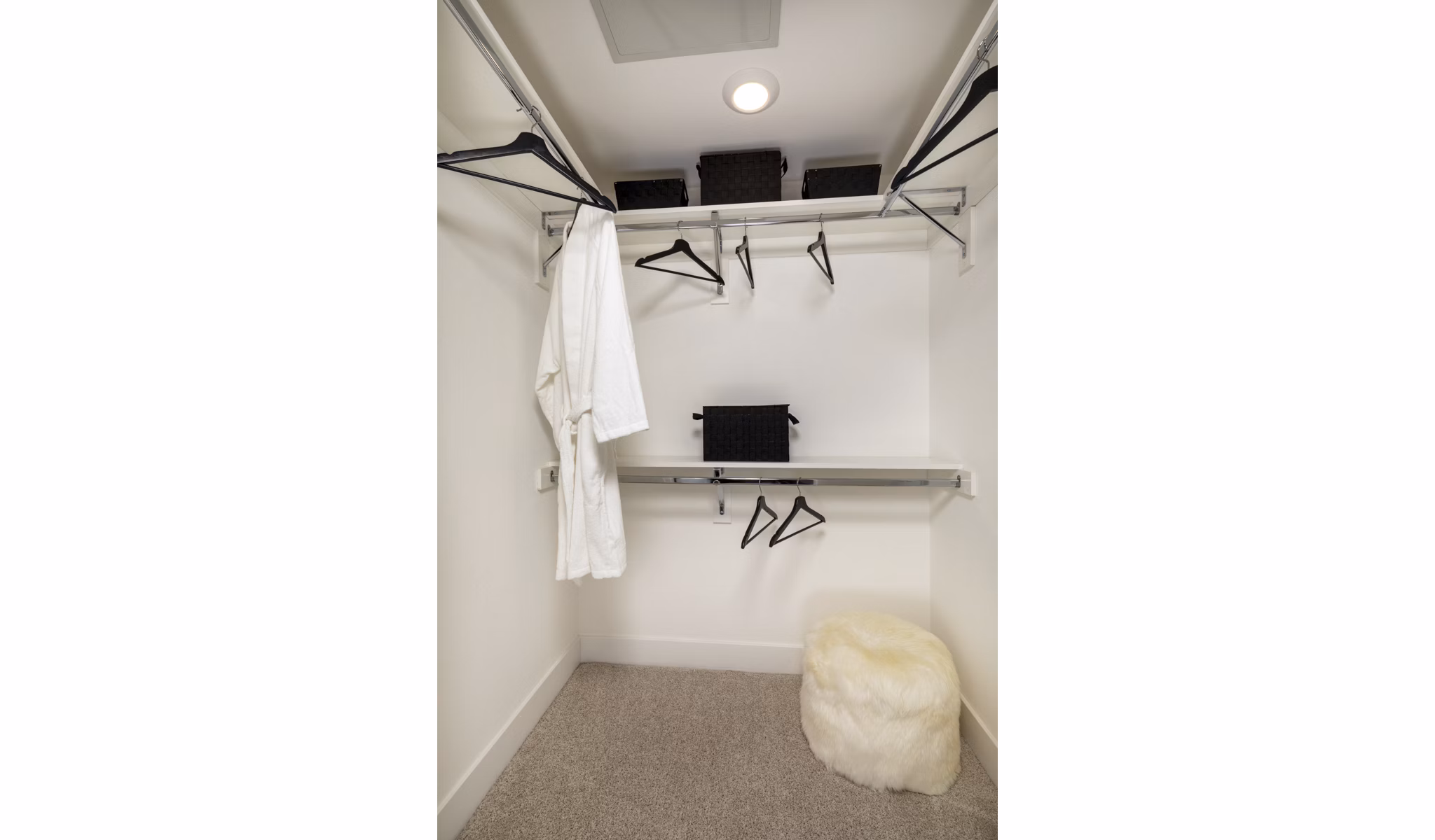 Walk-in closet with ample storage and modern shelving at Clarendon Apartments