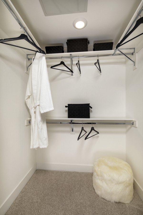 Walk-in closet with ample storage and modern shelving at Clarendon Apartments