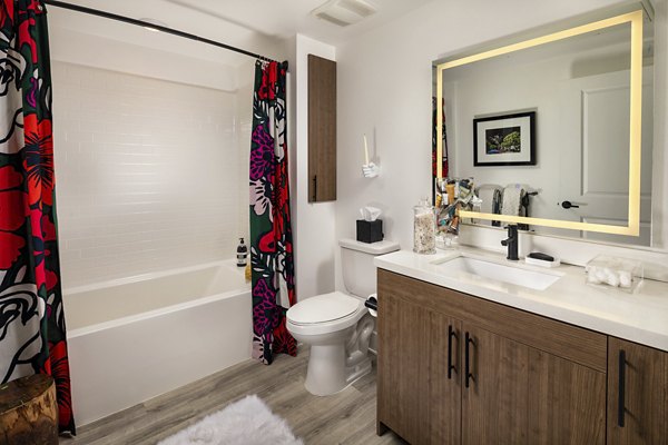 Bathroom featuring modern fixtures and elegant tile design at Clarendon Apartments