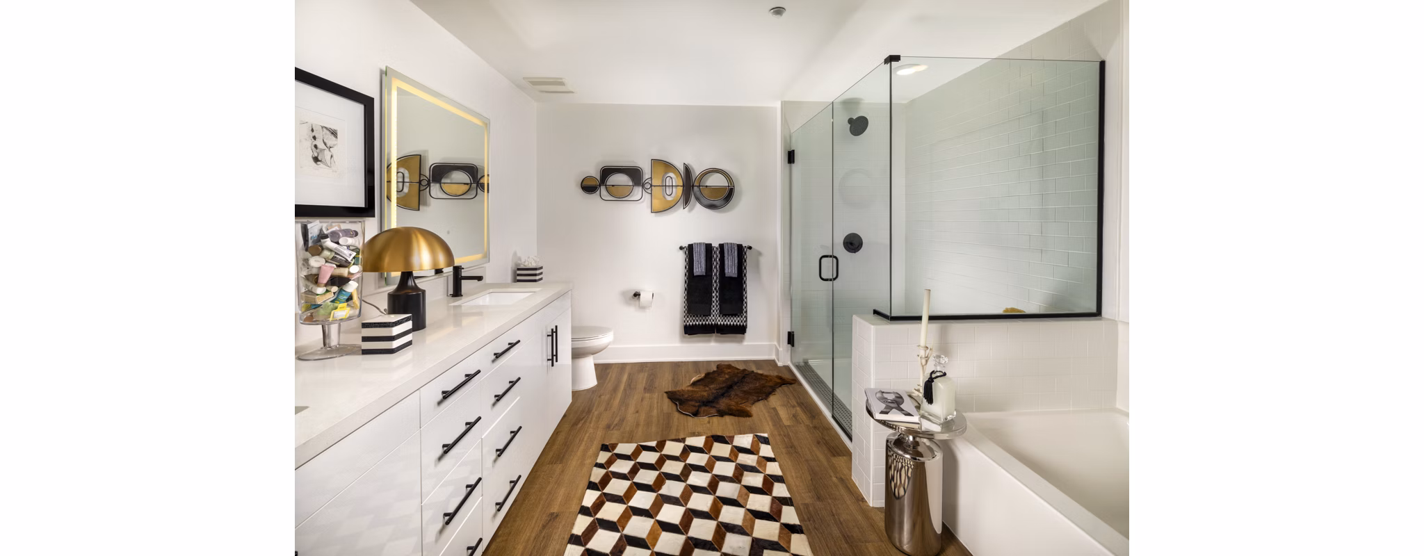 Bathroom with marble countertops and modern fixtures at Clarendon Apartments