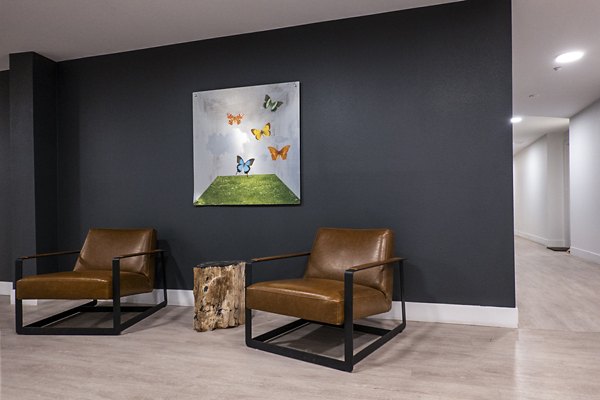 Clarendon Apartments: Elegant clubhouse lobby with modern decor and seating areas for luxury living