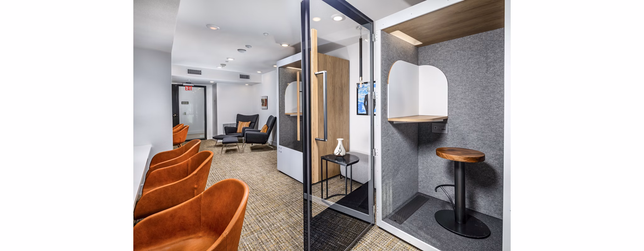 Modern business center with workstations at Clarendon Apartments, a luxury property by Greystar