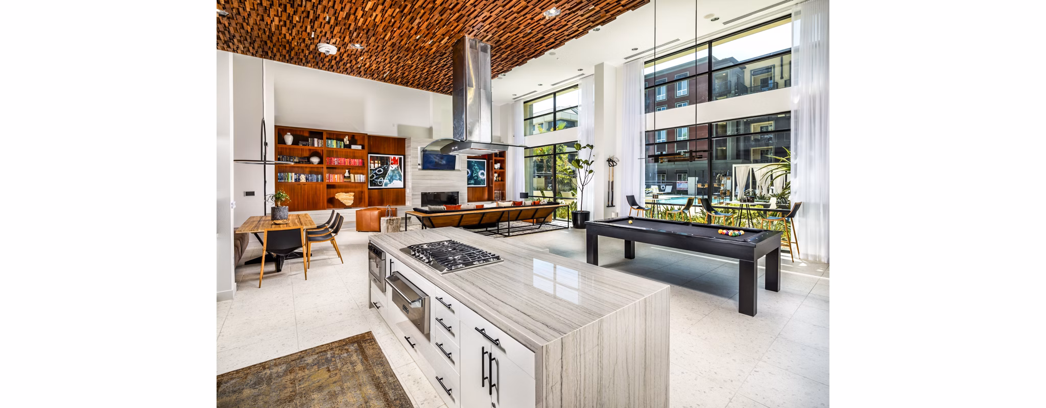 Modern game room featuring pool tables and lounge seating at Clarendon Apartments luxury community
