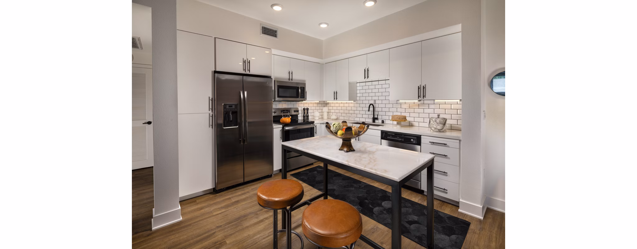 Contemporary kitchen with modern appliances at Clarendon Apartments, luxury living by Greystar