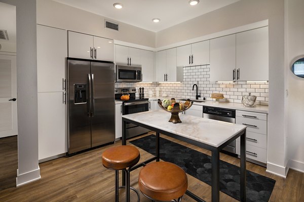 Contemporary kitchen with modern appliances at Clarendon Apartments, luxury living by Greystar