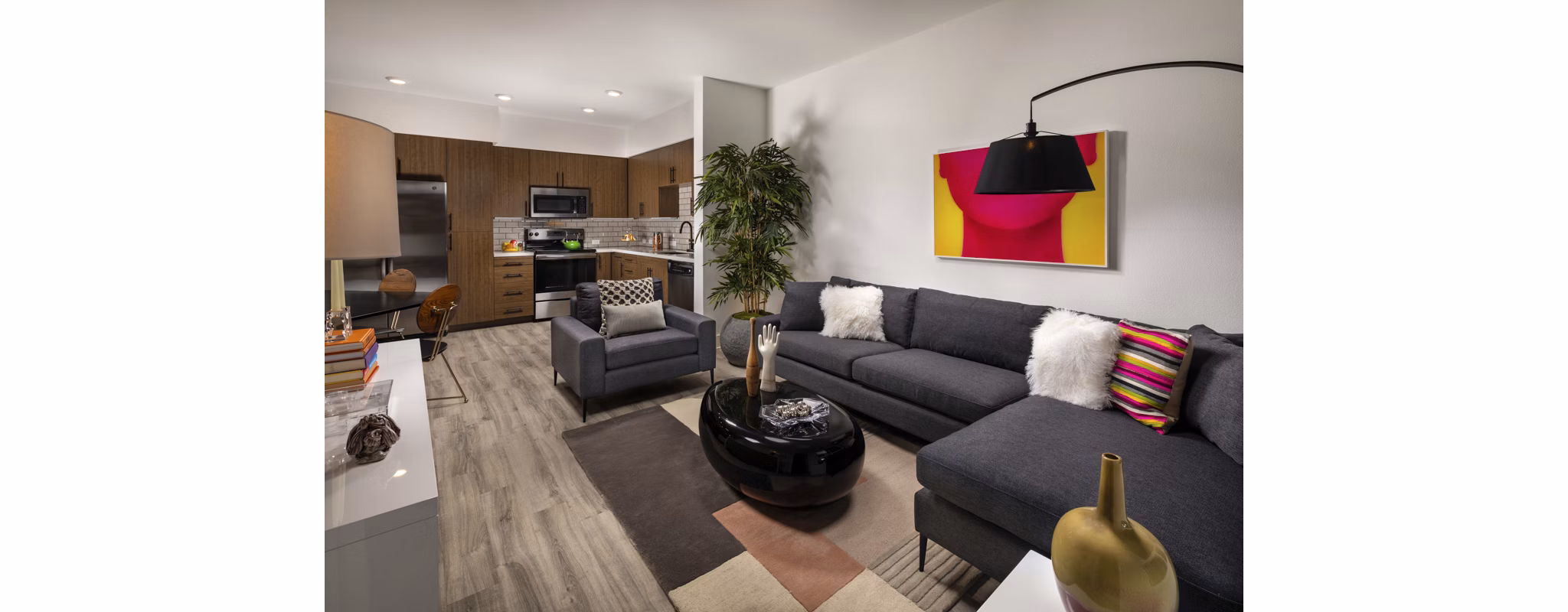 Spacious living room with modern decor and large windows at Clarendon Apartments