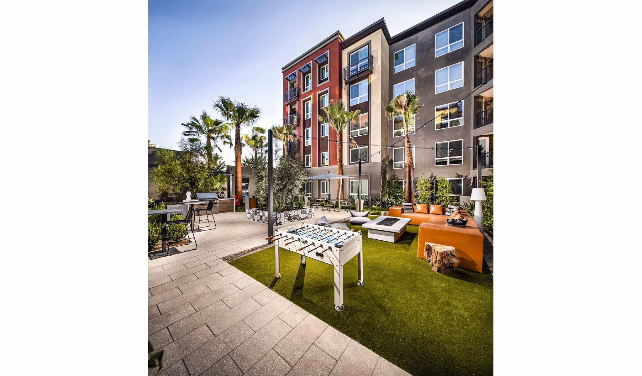 Outdoor grill area and sport court at Clarendon Apartments, perfect for active lifestyles and community gatherings