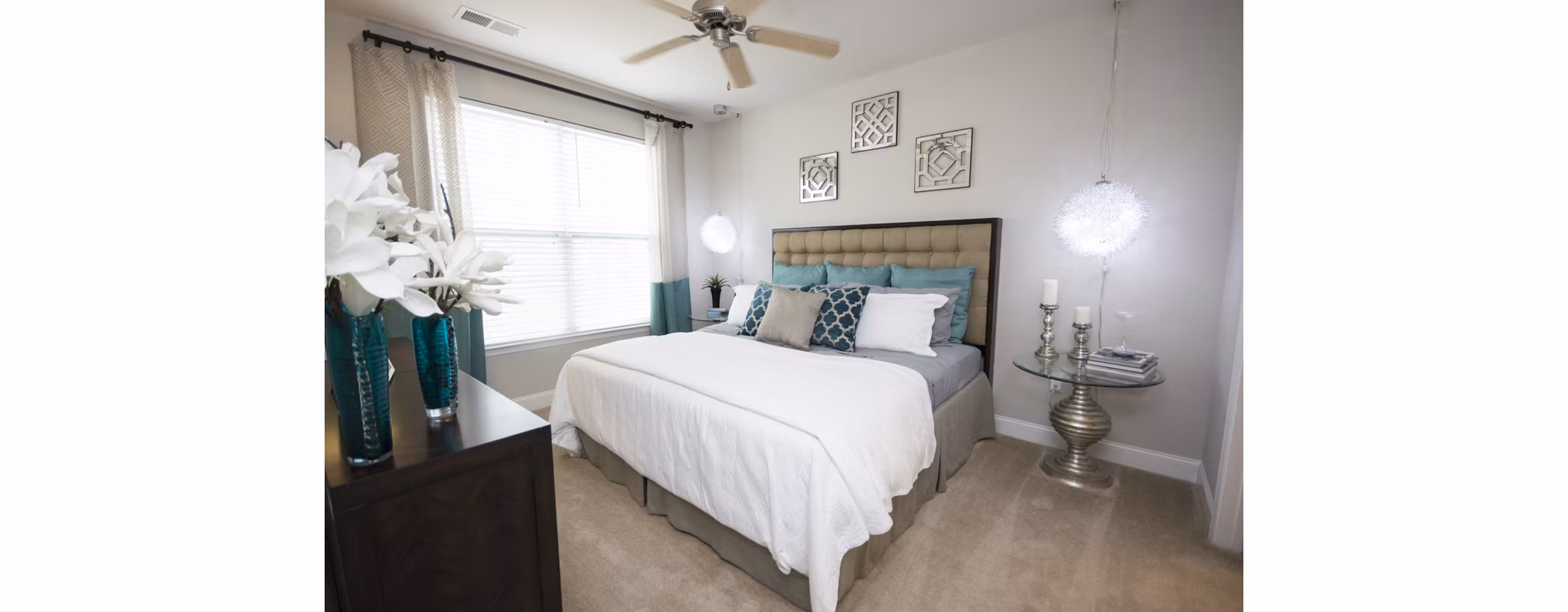 Cozy bedroom with elegant decor and large window at Tryon Place Apartments