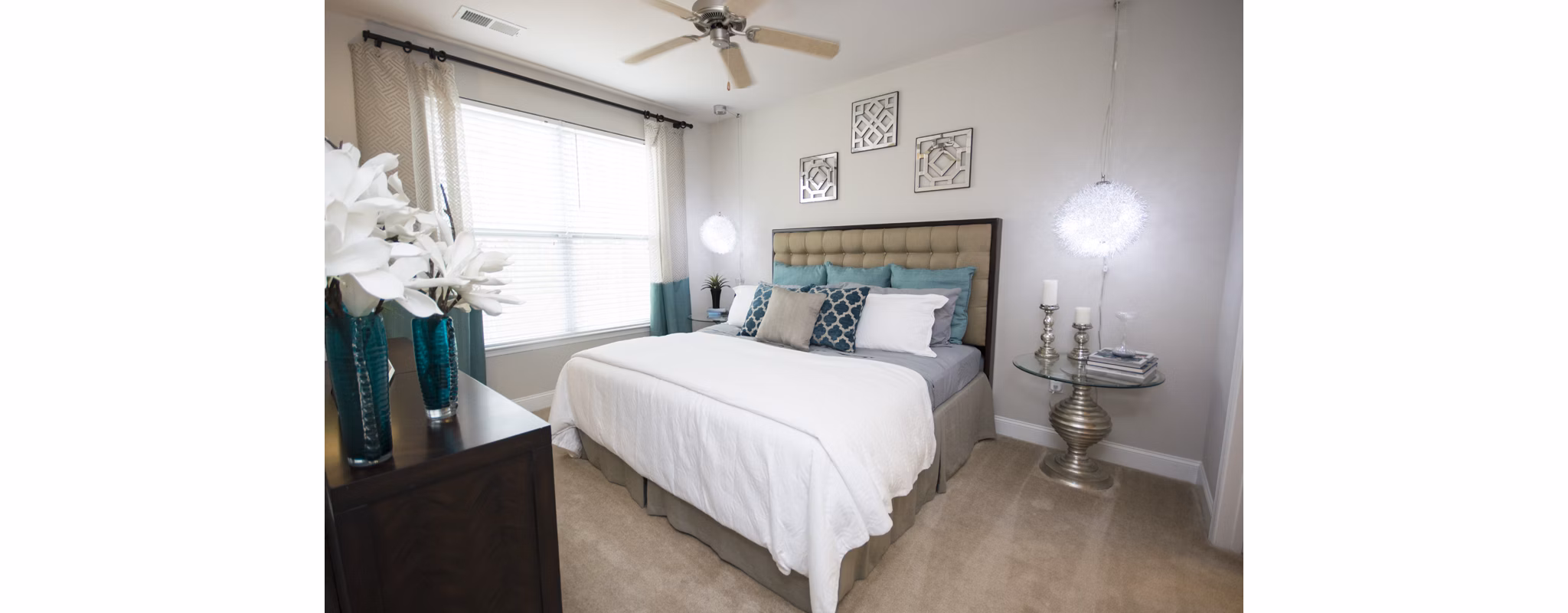Cozy bedroom with elegant decor and large window at Tryon Place Apartments