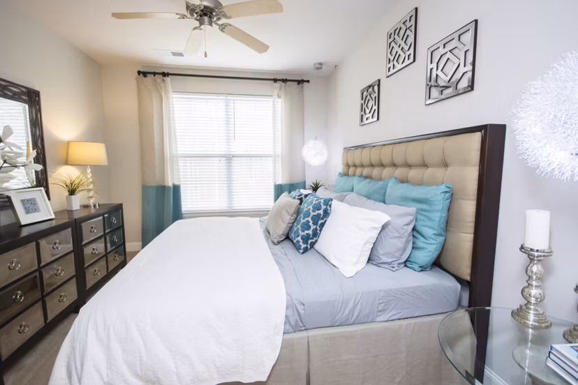 Cozy bedroom with modern decor at Tryon Place Apartments, ideal for urban living and comfort seekers in a luxury setting