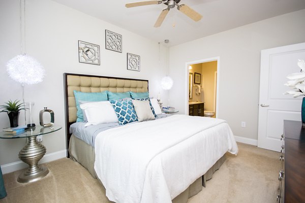 Bedroom with stylish decor and large windows at Tryon Place Apartments Luxury living experience in a well-designed Greystar community
