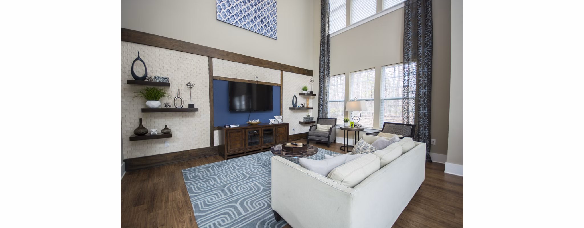Modern clubhouse with lounge seating and billiard table at Tryon Place Apartments in Raleigh, ideal for social gatherings and relaxation